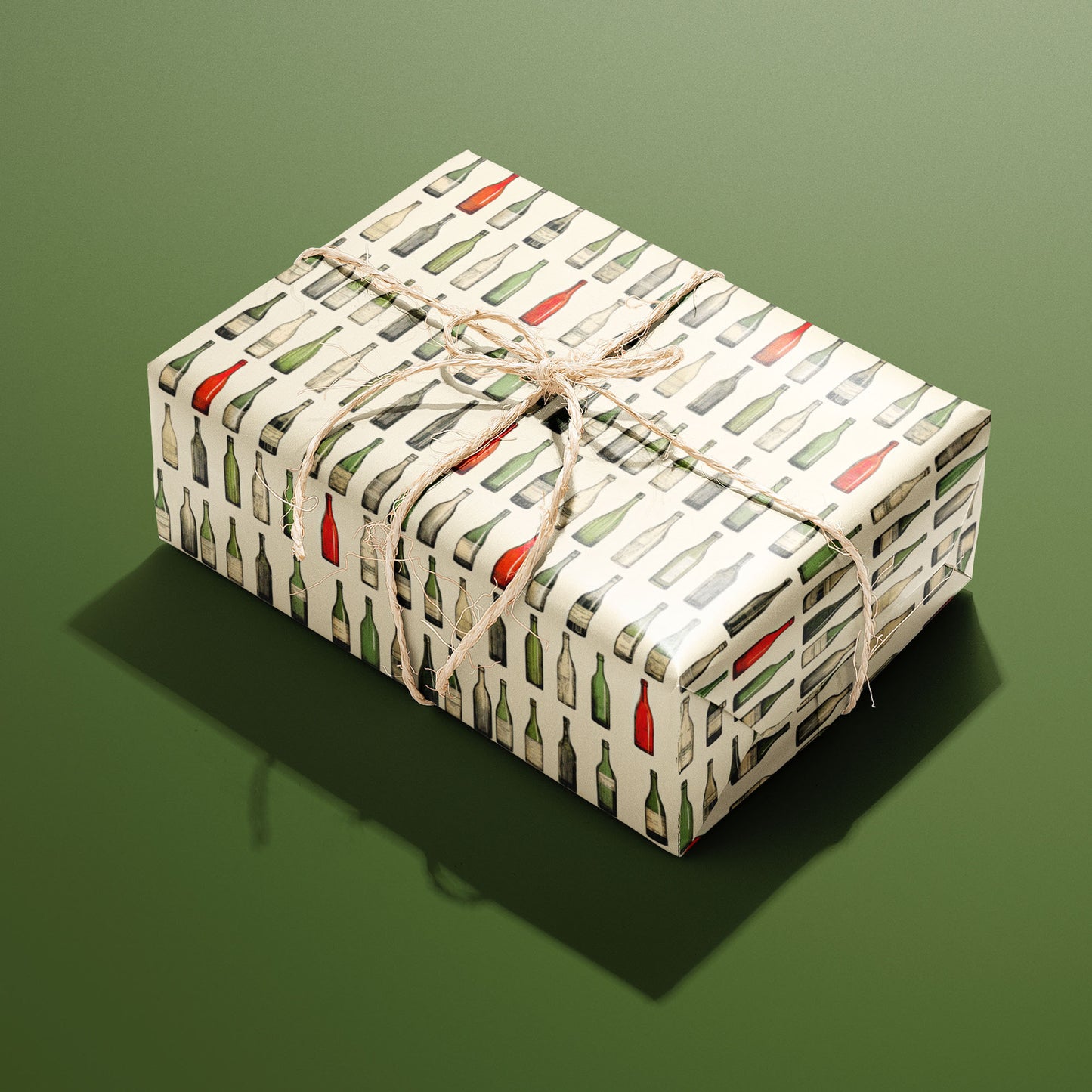 A single rectangular gift wrapped in Classic Vino—rows of watercolor wine bottles on cream—tied with natural twine on an olive green background.