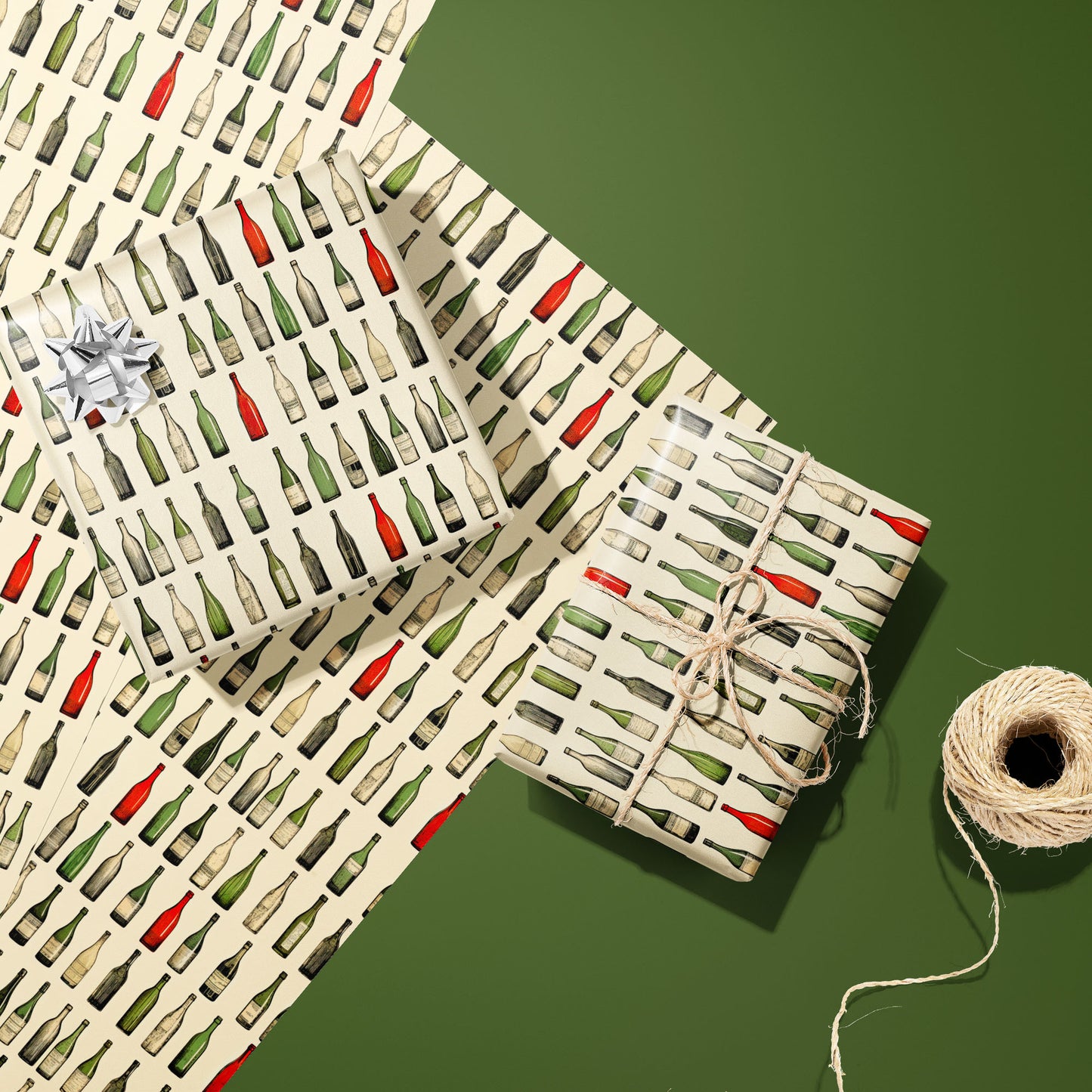 Two gifts in Classic Vino—one with a silver bow and one tied with twine—rest on two unused sheets beside a spool of twine on an olive green background.