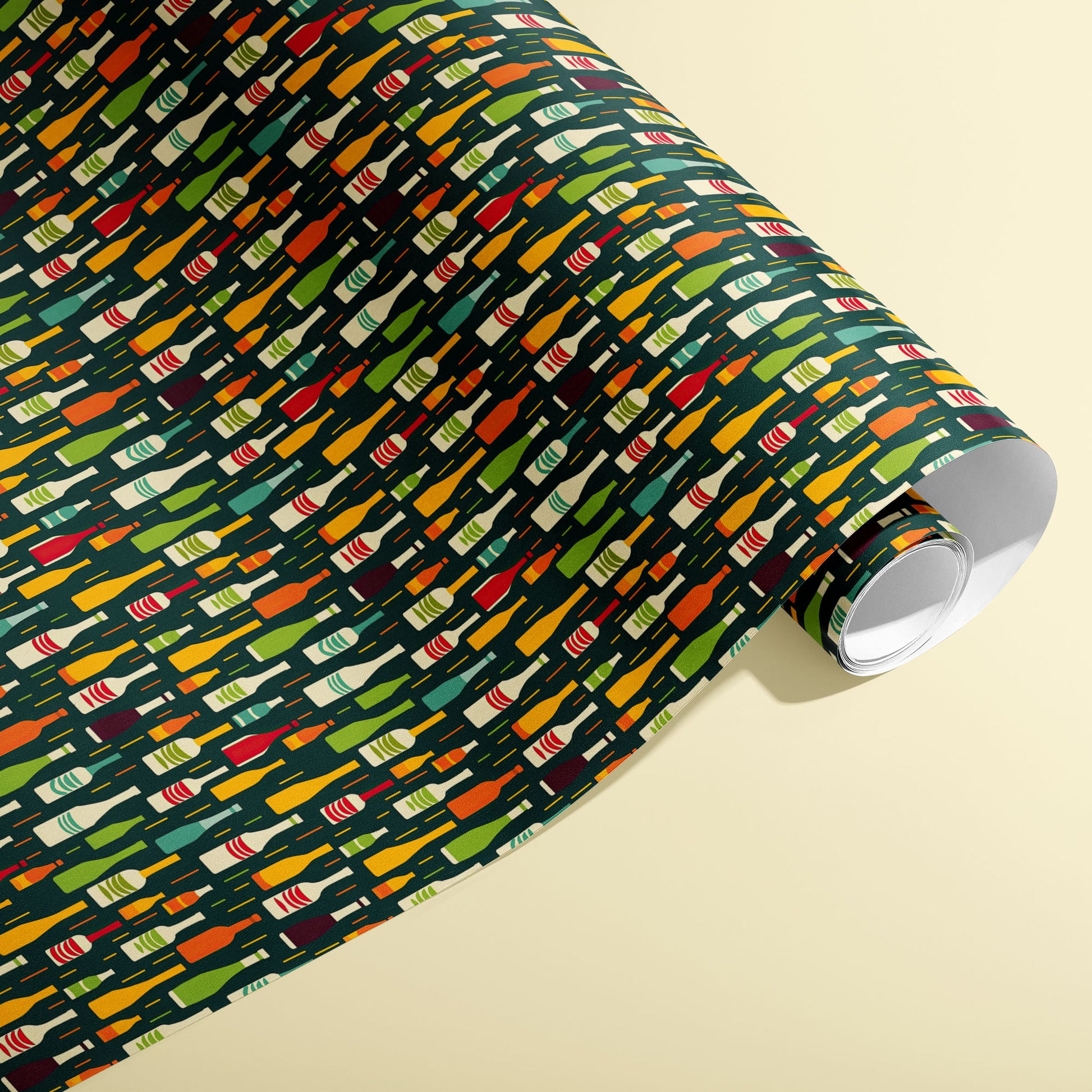 A partially unfurled roll of Wine Bottle Silhouettes shows scattered red, green, and gold bottle motifs on a deep green field against a cream background.