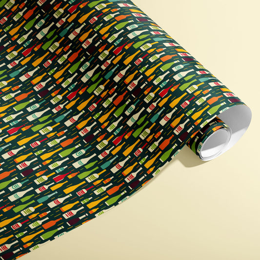 A partially unfurled roll of Wine Bottle Silhouettes shows scattered red, green, and gold bottle motifs on a deep green field against a cream background.
