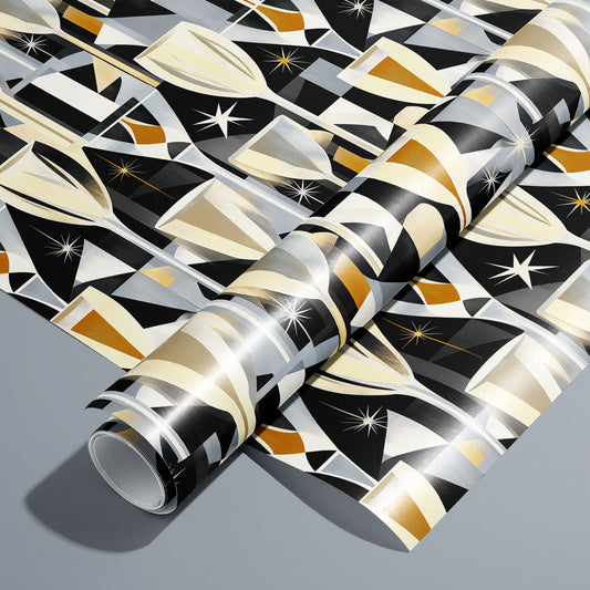 A roll of Toast to Elegance wrapping paper on an unrolled sheet, featuring champagne flutes, clinking coupes, bubbles, and starbursts in soft gold on black, set on a silver-grey surface.
