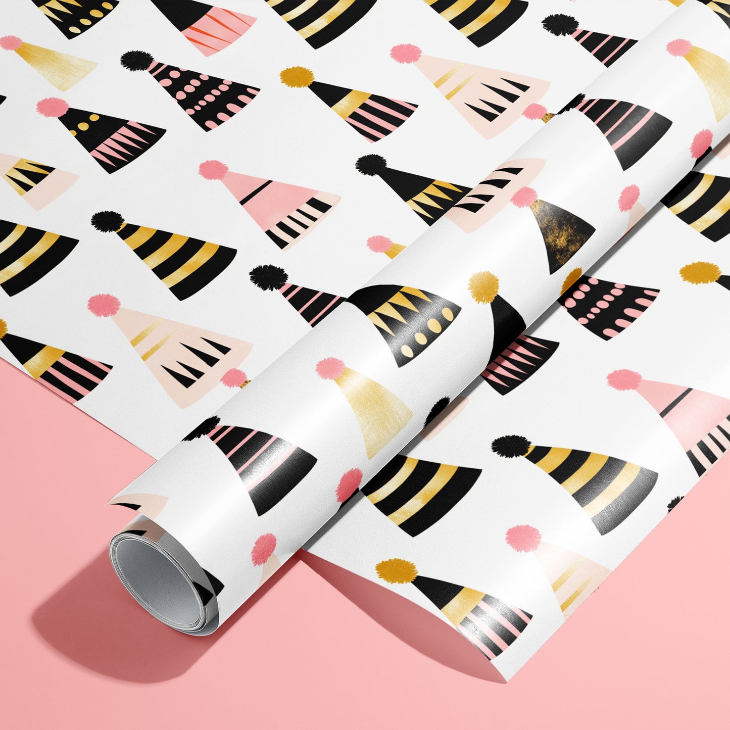 A roll on an unrolled sheet of Party Hat Parade wrapping paper with colorful party hat and pom-poms, set on a bright pink background.
