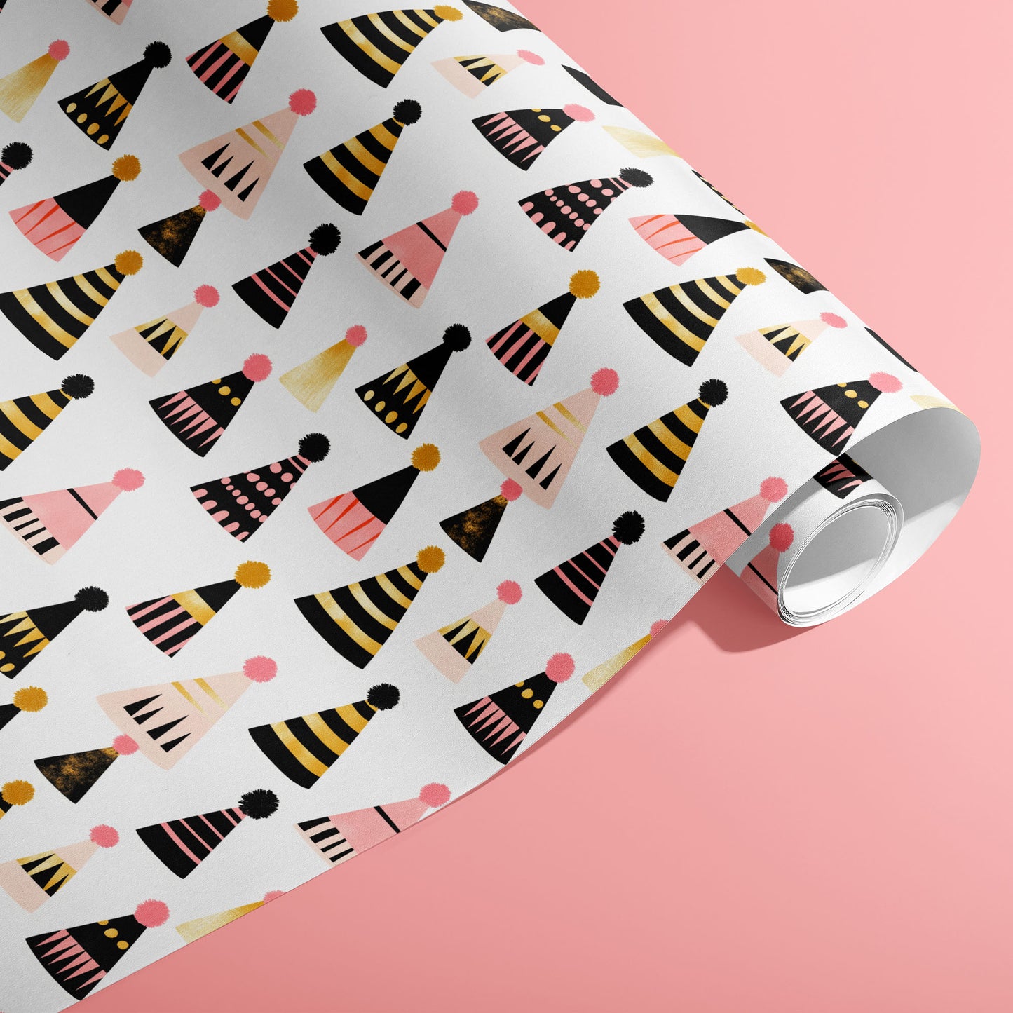 A partially unfurled roll of Party Hat Parade wrap showing playful patterned party hats on a bright pink background.