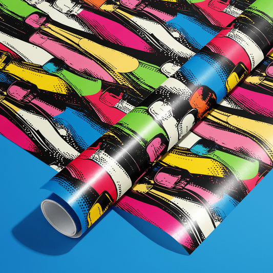 A roll of Bold Bottles rests on a matching unrolled sheet, featuring oversized pop-art bottle silhouettes in saturated colors on a deep charcoal ground, on a vivid blue surface.