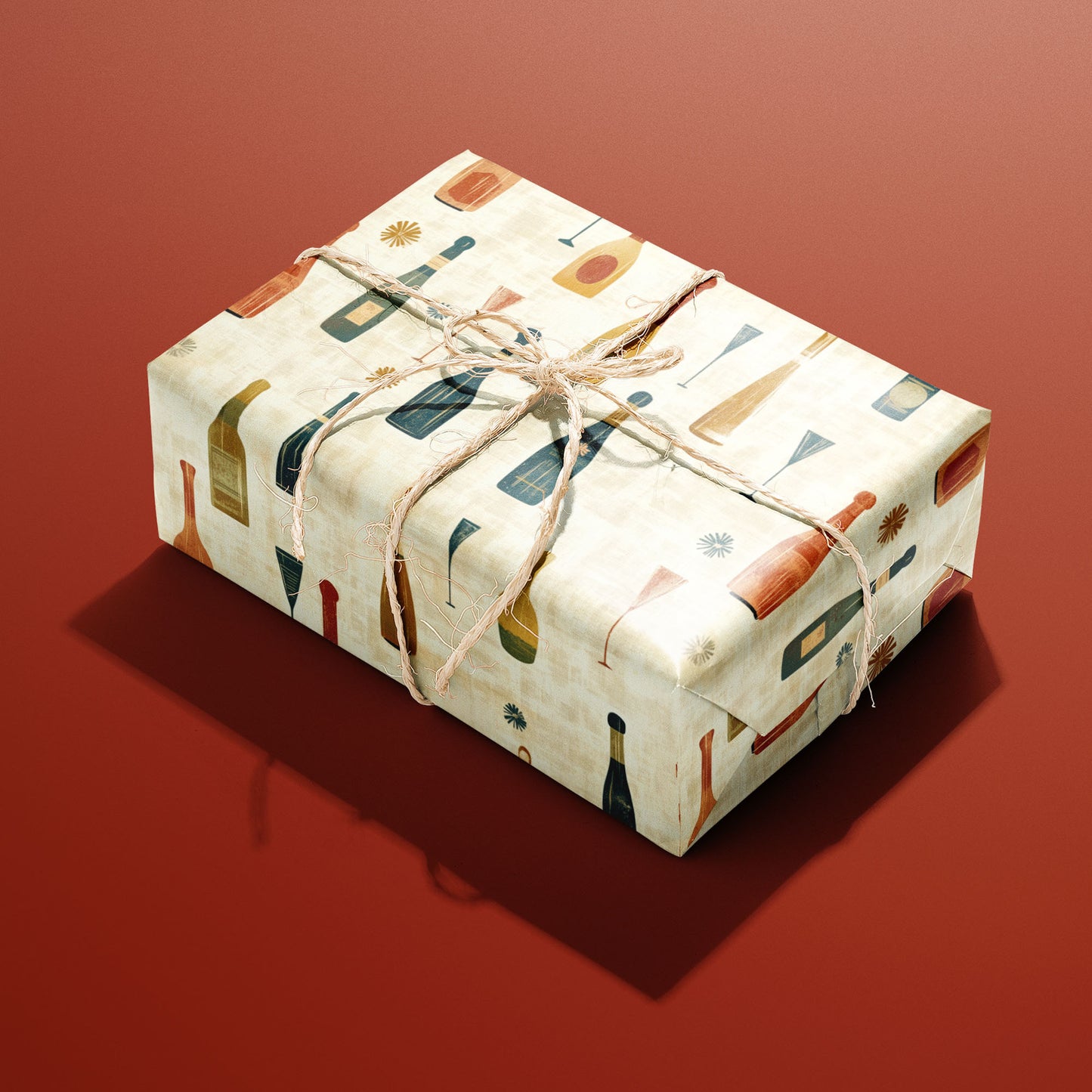 A single gift wrapped in Vintage Bubbly and tied with natural twine displays mid-century champagne motifs on a cream ground against a brick-red background.