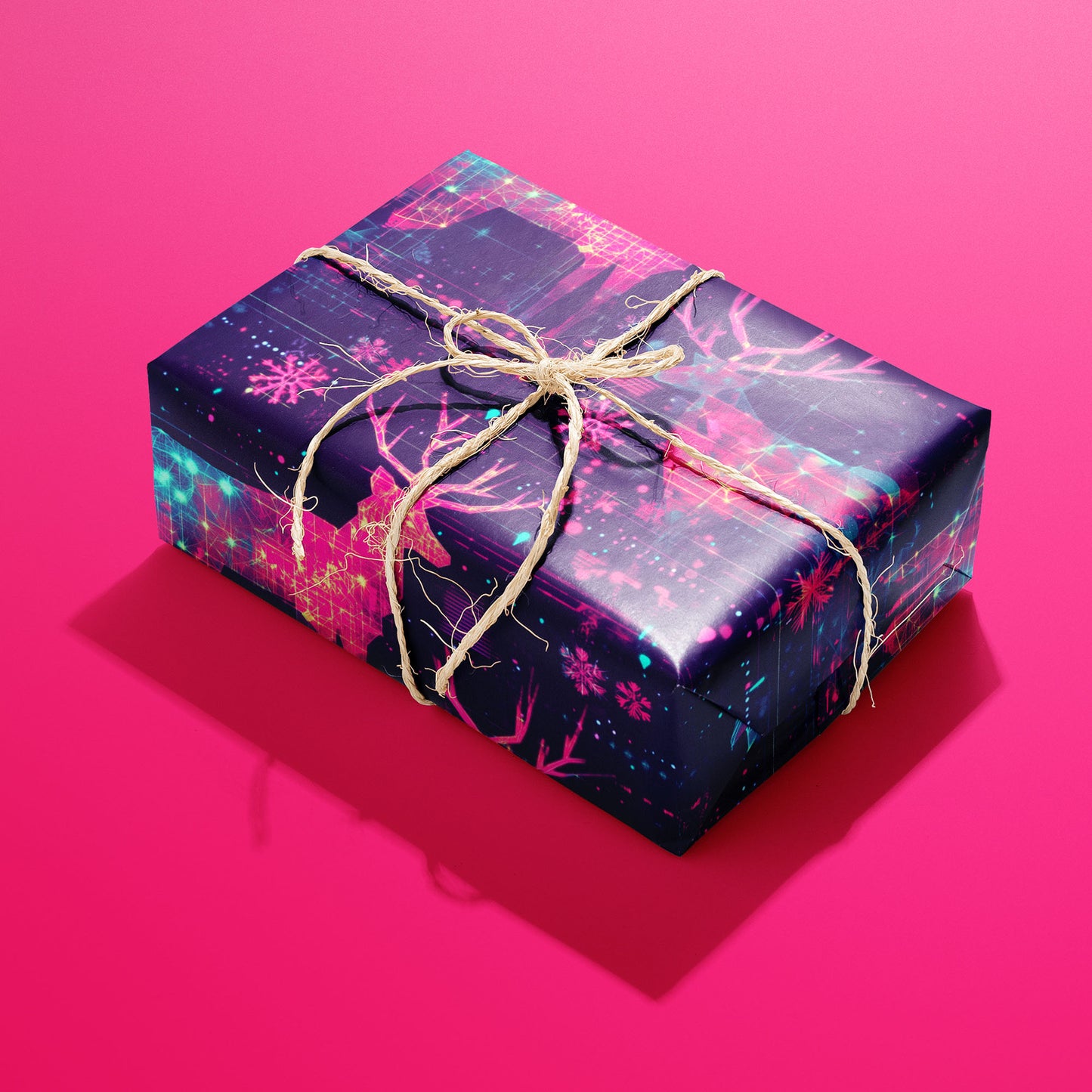 A single rectangular gift wrapped in Holographic Holiday and tied with natural twine highlights neon reindeer and digital snowflakes on a deep navy ground against a hot pink backdrop.