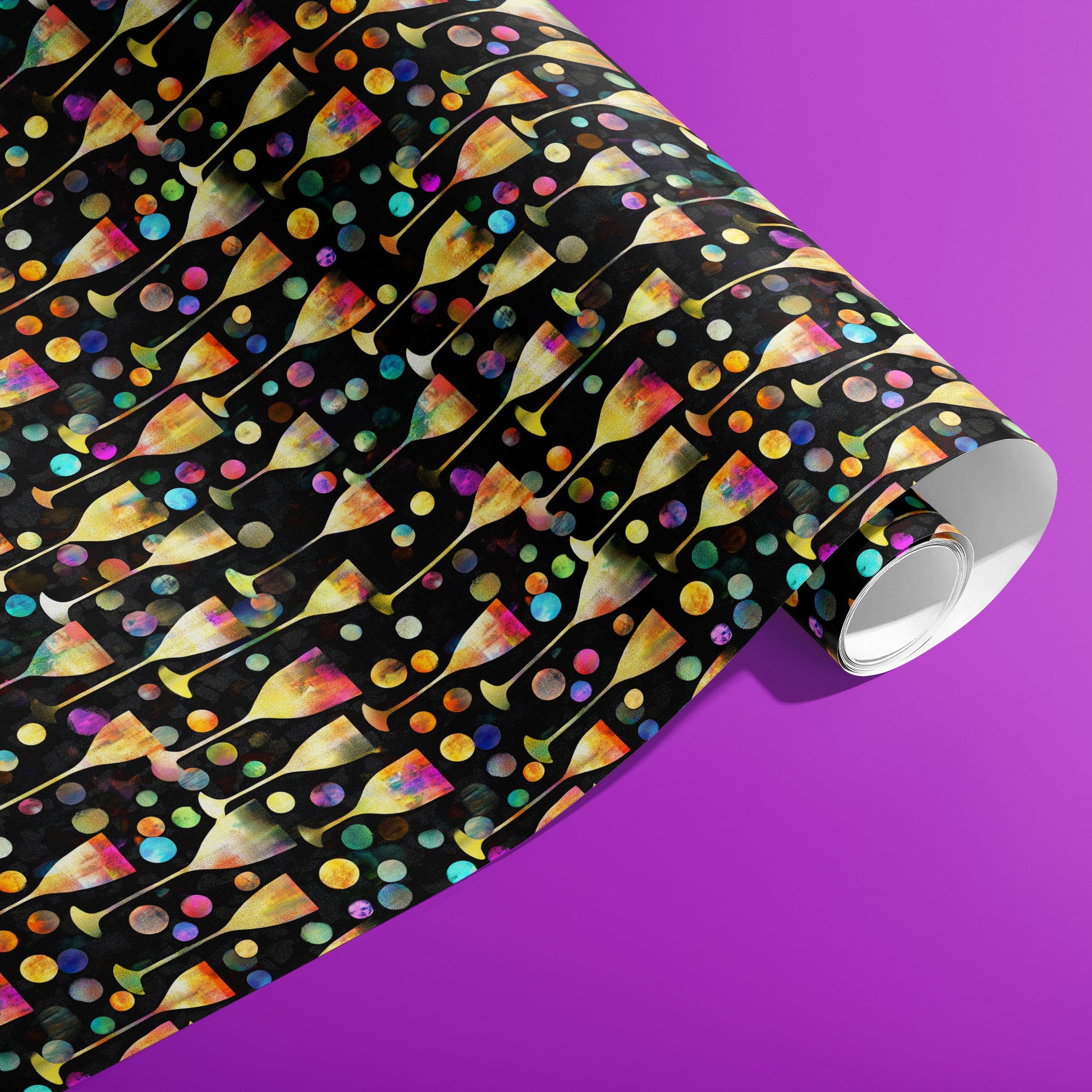 A partially unfurled roll of Radiant Revelry wrapping paper reveals iridescent champagne flutes with rainbow bubbles on black against a vibrant purple background.