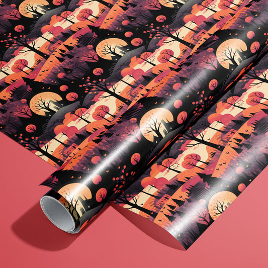 A roll of Halloween Landscape wrapping paper resting on a matching unrolled sheet, with moonlit trees, hills, and bats in warm oranges and blacks on a coral-red background.