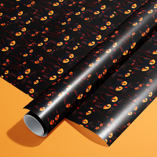 A roll of Cat’s Eyes rests on an unrolled sheet, showing glowing amber cat eyes and shadowy feline faces on black, styled on a bright orange surface.