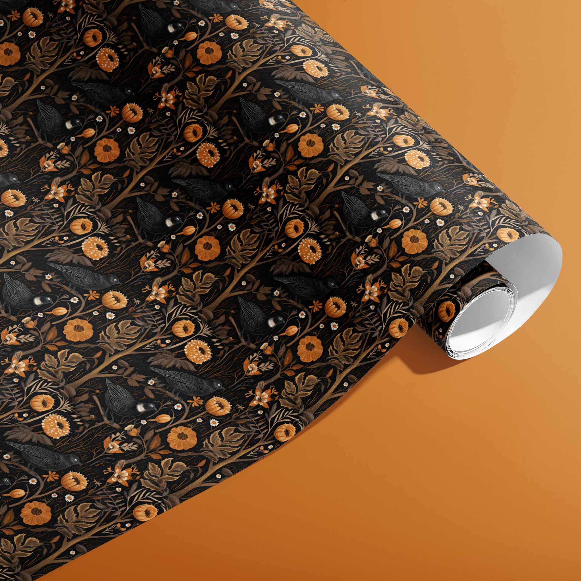 A partially unfurled roll of Autumn Floral wrapping paper showing rich autumn blossoms and foliage in orange, gold, and wine tones on a warm rust surface.