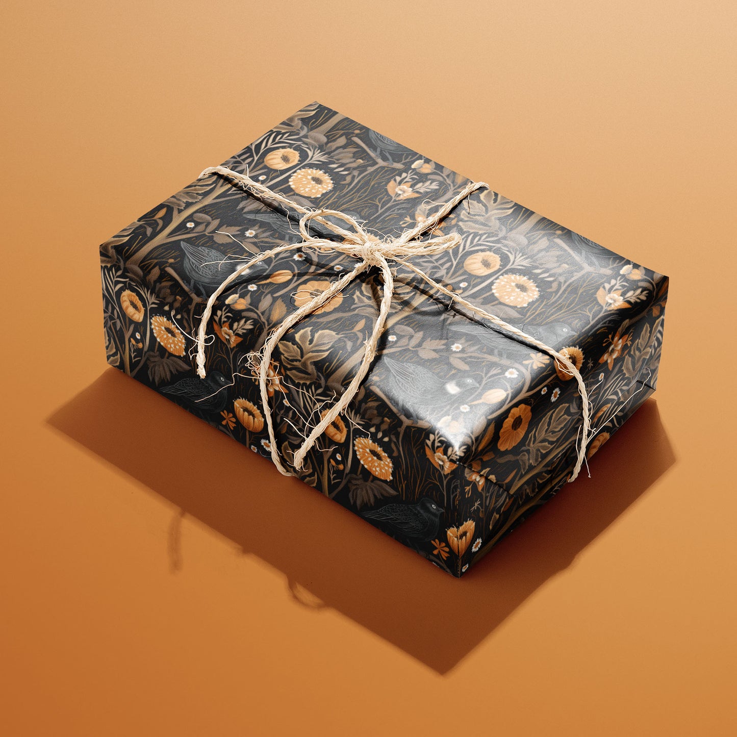 A single gift wrapped in Autumn Floral and tied with natural twine, displaying lush autumn blossoms and leaves in warm harvest hues on a rust-toned surface.