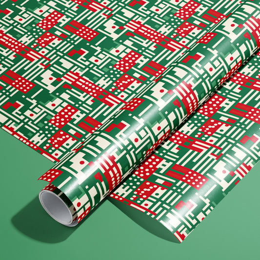 A full roll of Abstract Christmas wrapping paper on an unrolled sheet, showing modern geometric motifs—stripes, dots, and grids—in red, green, and cream on a green background.