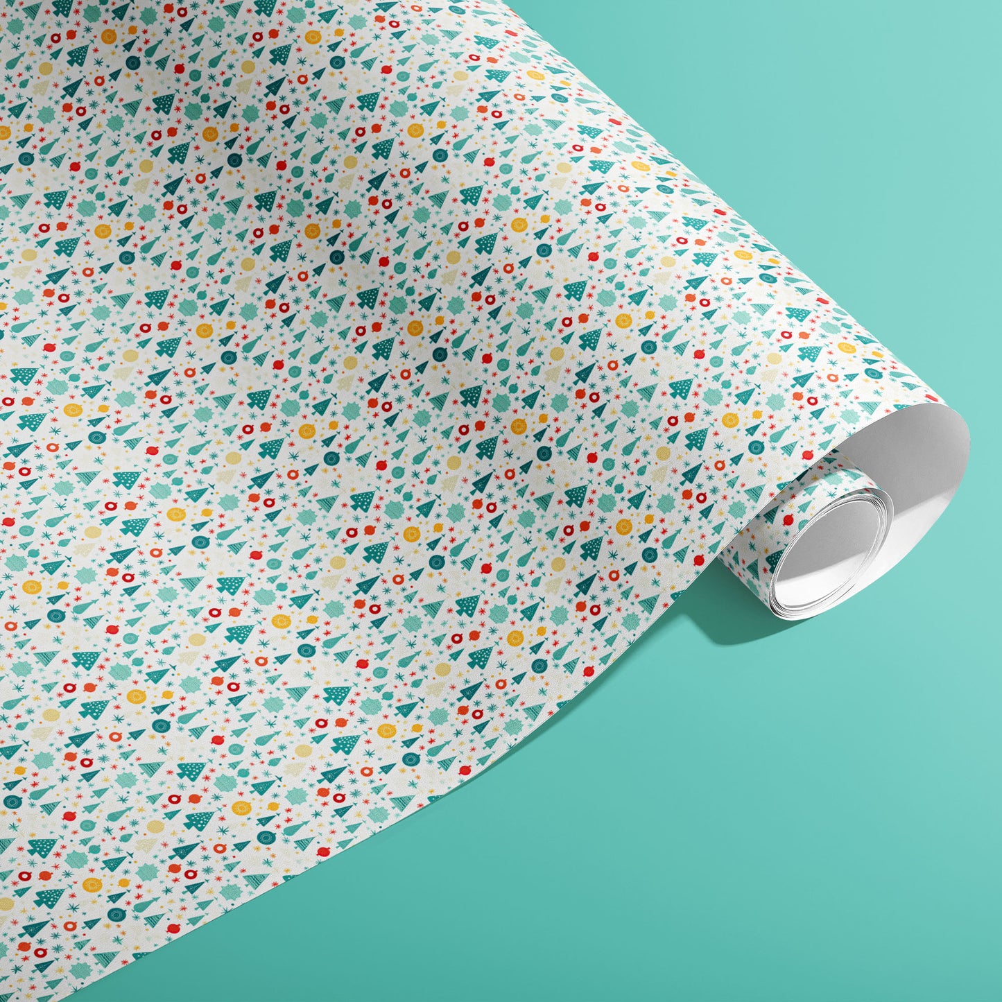 A partially unfurled roll of Childlike Christmas giftwrap showing playful doodles of trees, stars, snowflakes and ornaments on a soft mint-green surface.