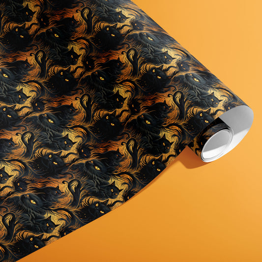 A partially unfurled roll of Feline Flames shows midnight cats and flickering flame swirls with ember specks across a dark field against a pumpkin-orange backdrop.