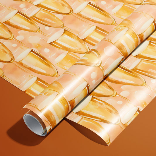 A roll on an unrolled sheet of Shimmering Sips wrapping paper with watercolor champagne flutes and fizzy bubbles on a peach ground, set on a rich copper-orange background.