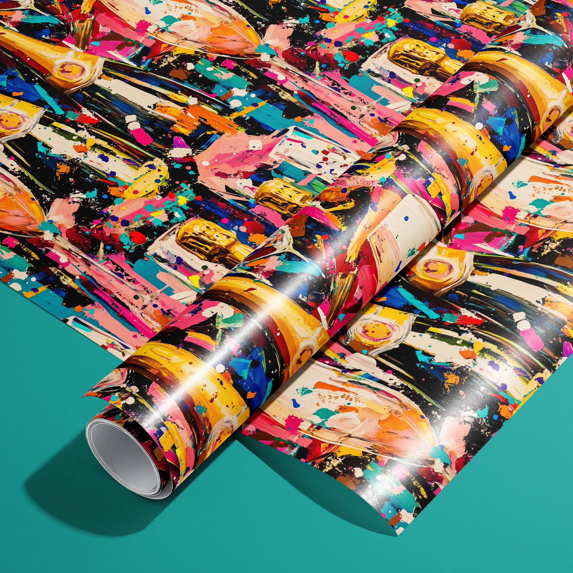 A roll of Cheers in Color wrapping paper on an unrolled sheet, featuring champagne bottles, flutes, and paint-splatter confetti on a dark ground, set on a teal background.
