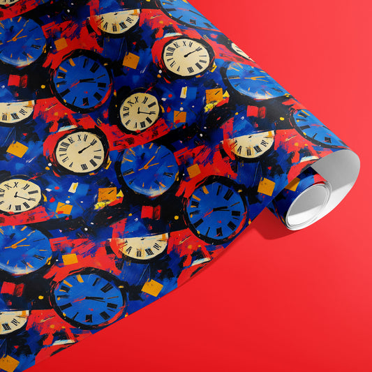 A partially unfurled roll of Timeless Celebration shows ivory and blue clock faces with Roman numerals amid painterly confetti strokes on black against a bright red backdrop.