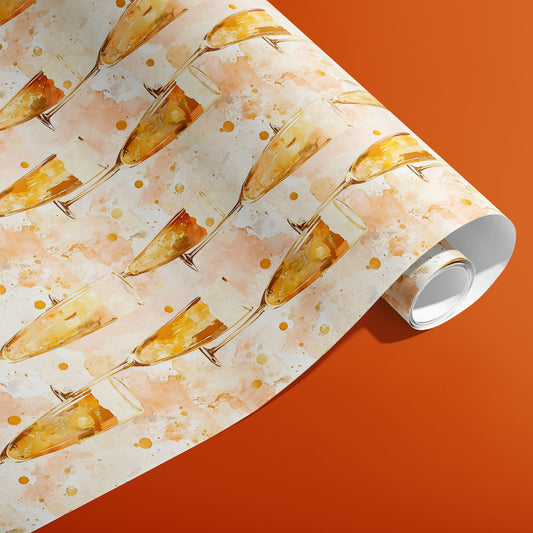 A partially unfurled roll of Sparkling Celebrations displays golden champagne flutes with watercolor splashes on a blush cream field against an orange backdrop.