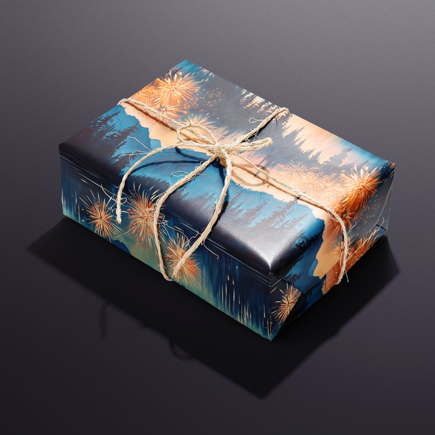 A single gift wrapped in Radiant Reflections and tied with natural twine displays a mountain lake scene with fireworks and mirrored glow against a charcoal-purple background.