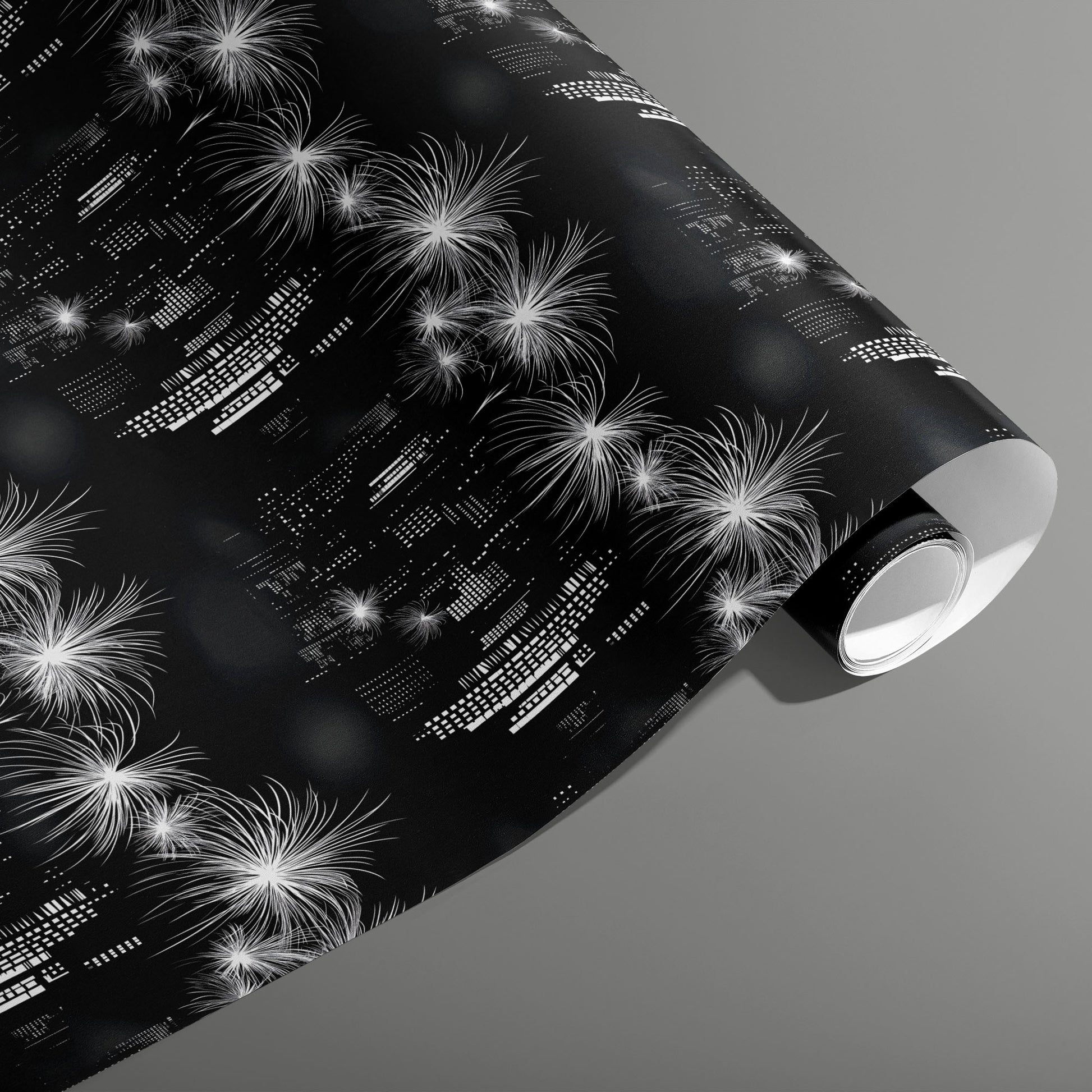 A partially unfurled roll of Skyline Magic featuring monochrome skyscraper lights and bursting fireworks on a black ground, set on a medium gray background.