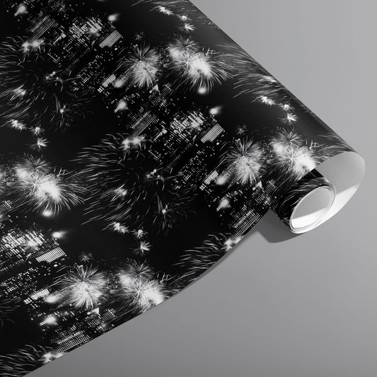 A partially unfurled roll of Skyline Celebration wrapping paper featuring glowing city lights and white fireworks over a black ground on a cool gray background.
