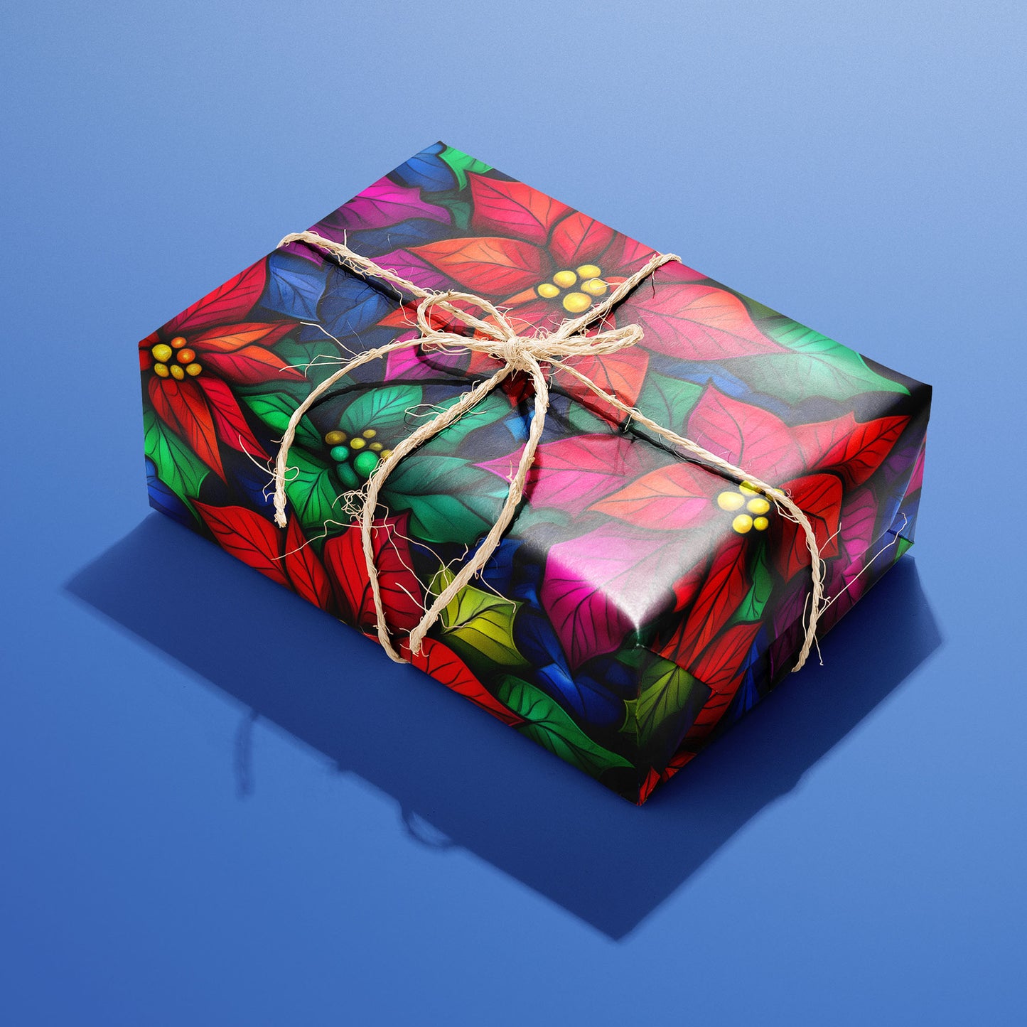A single rectangular gift wrapped in Bold Blooms and tied with natural twine, its radiant poinsettias and jewel-tone leaves glowing on black over a cobalt-blue background.