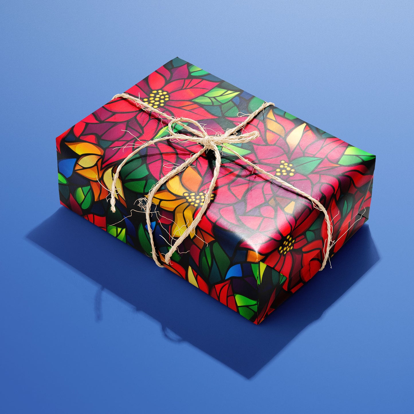 A single rectangular gift wrapped in Poinsettia Prism and tied with natural twine, its stained-glass poinsettias glowing on a black print against a cobalt-blue background.