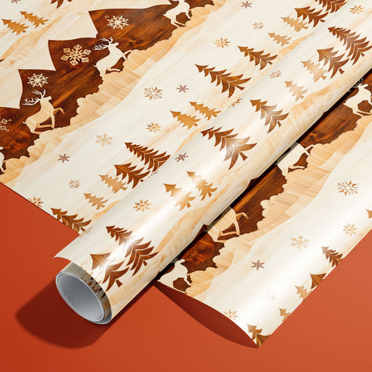 A roll of Rustic Reindeer rests on a matching unrolled sheet, showing woodgrain reindeer, fir trees, and snowflakes in warm browns on cream, on a burnt-orange surface.