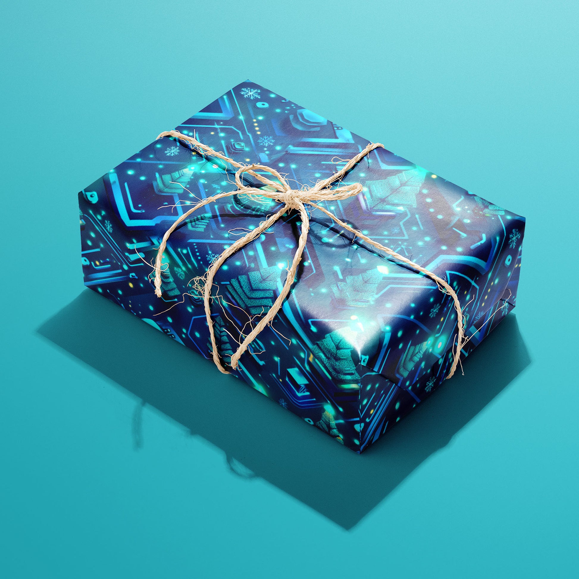 A single rectangular gift wrapped in Xmas Grid and tied with natural twine shows neon circuit motifs with chips, snowflakes, and trees on deep navy against a teal backdrop.