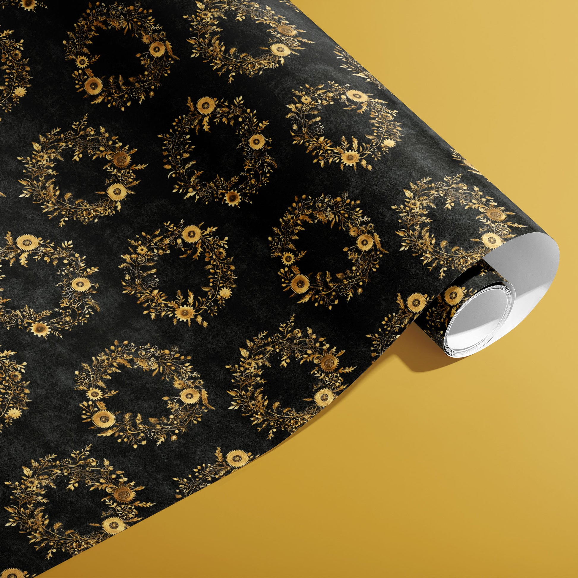 A partially unfurled roll of Clockwork Wreaths paper showing gold mechanical cog wreaths and leafy flourishes across a textured black ground on a mustard-yellow background.