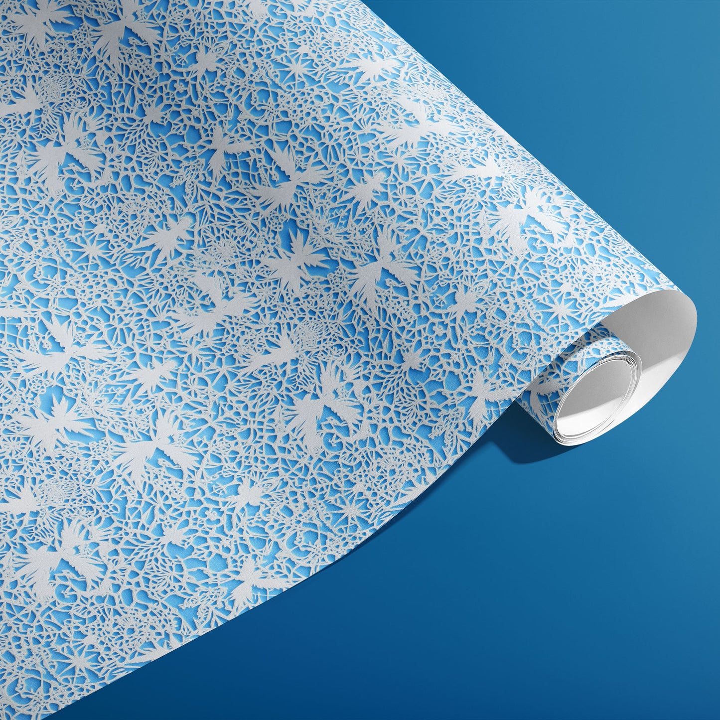 A partially unfurled roll of Winter's Whisper reveals delicate white botanical filigree and snowflakes on an icy blue field against a deep blue backdrop.