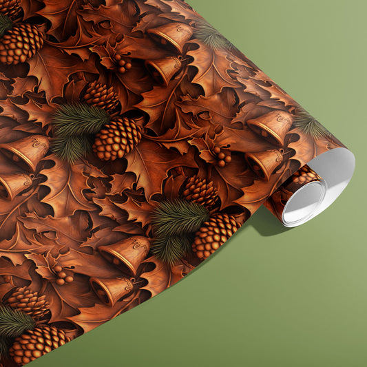 A partially unfurled roll of Timberland Treasures wrapping paper with carved-wood oak leaves, pinecones, and bells in rich browns displayed on a sage green surface.