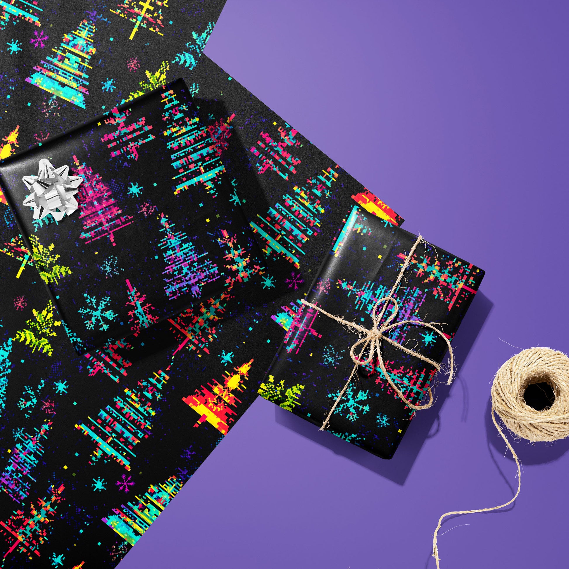 Two Glitchmas Trees gifts—one with a silver bow and one tied with twine—rest on two unused sheets beside a twine spool on an electric purple surface, showing pixel-shifted trees.