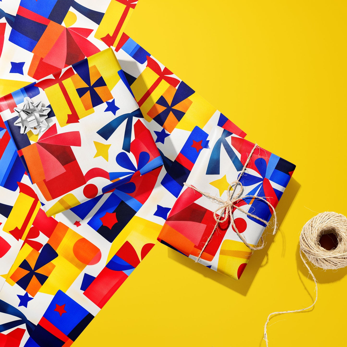 Two gifts wrapped in Vivid Vintage—one with a silver bow, one tied with twine—rest on two unused sheets beside a twine spool on a bright yellow background, with retro gifts and stars.