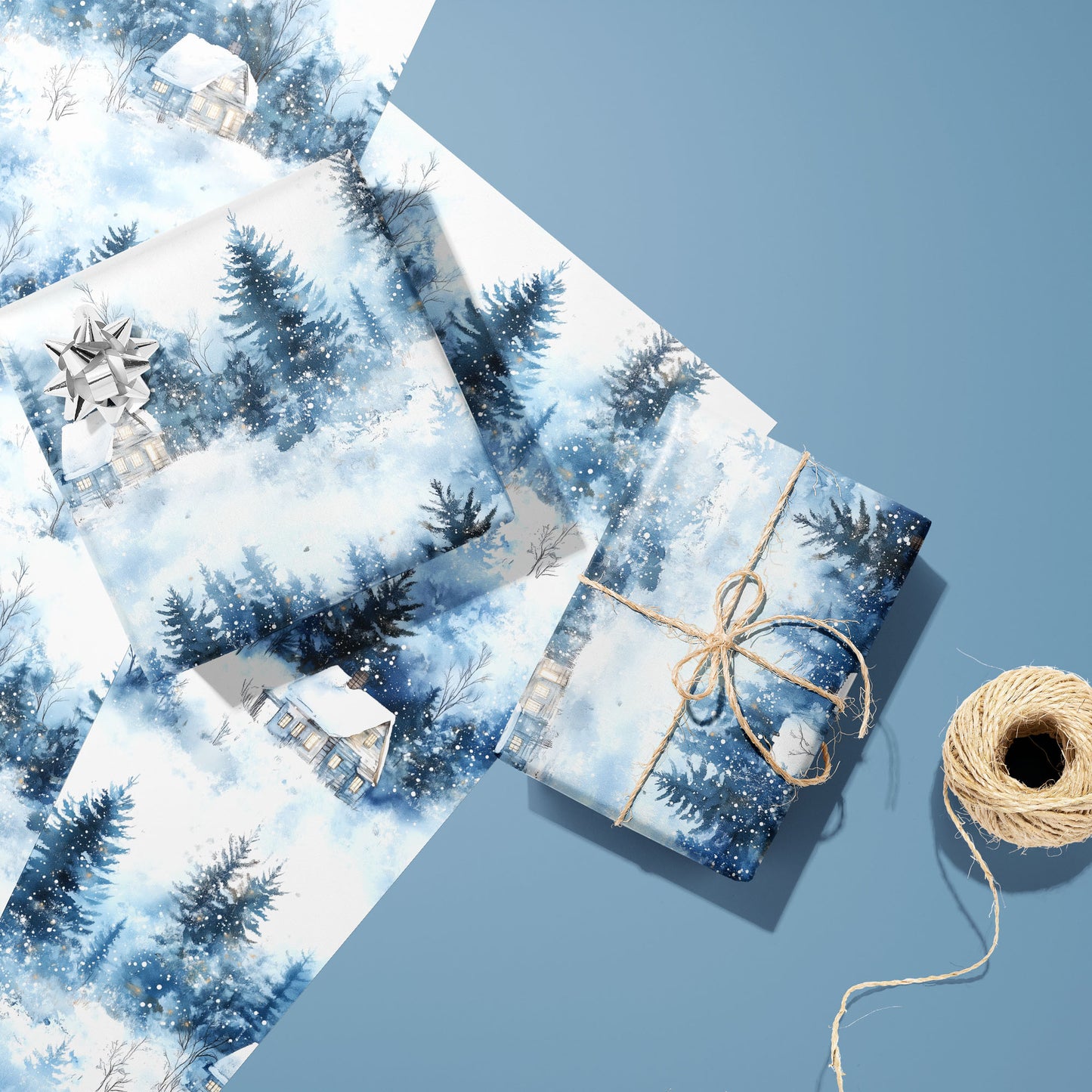 Two gifts in Winter's Calm—one with a silver bow and one tied with twine—rest on two unused sheets beside a spool of twine on a dusty blue background.