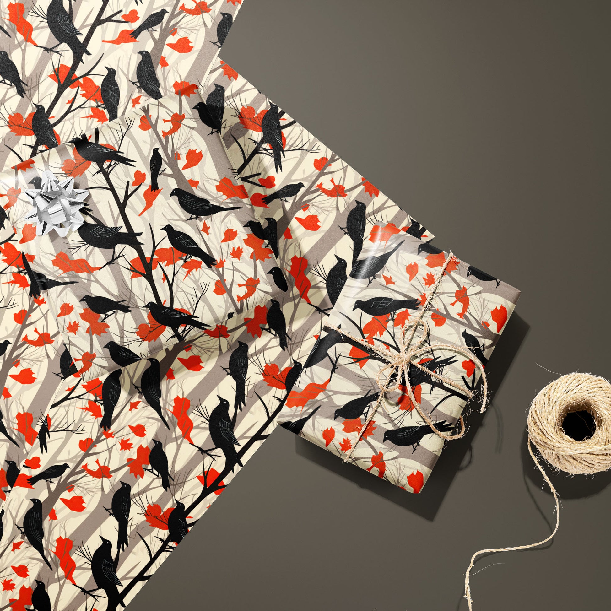 Two gifts in Raven's Reverie—one with a silver bow and one tied with twine—rest on two unused sheets beside a spool of twine on a smoky taupe background.