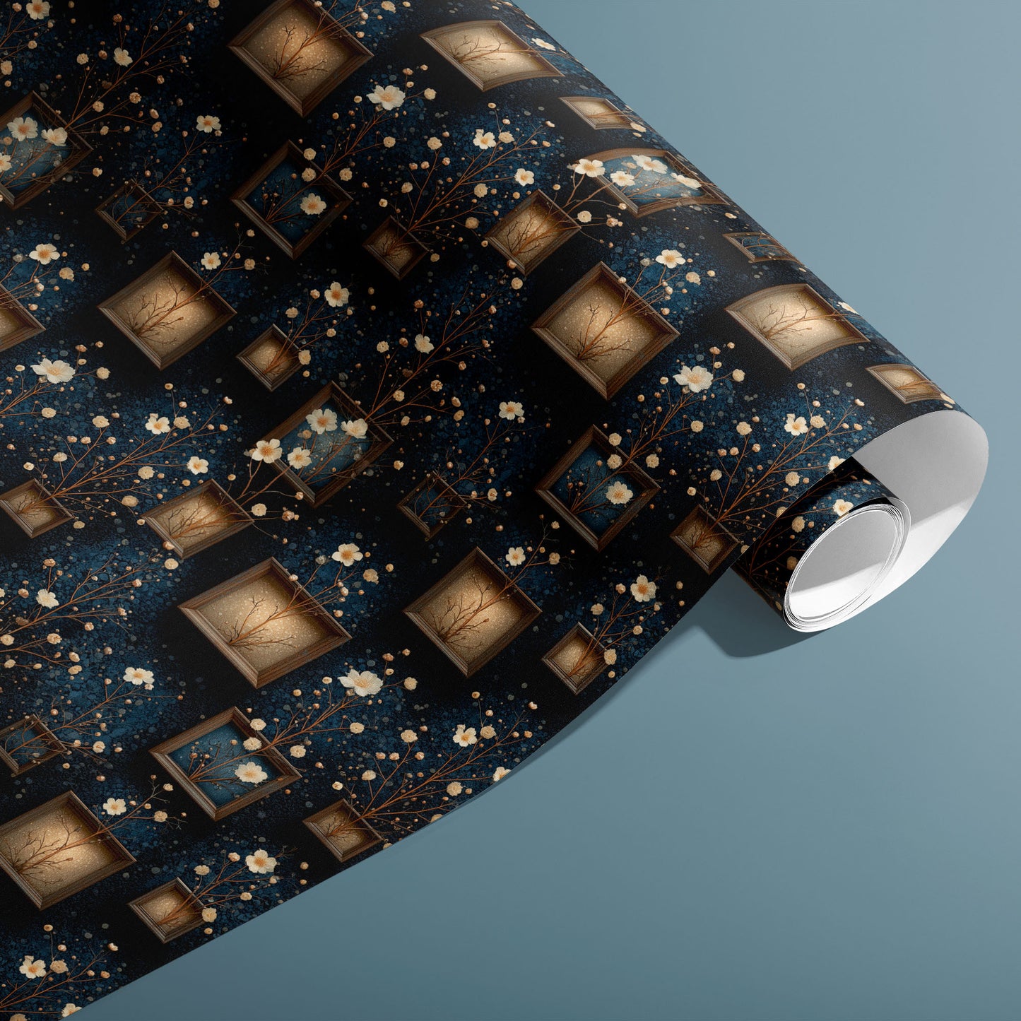A partially unfurled roll of Curio Florarium gift wrap reveals its vintage frames and cream blossoms with gold branches on deep navy, styled against a muted teal background.