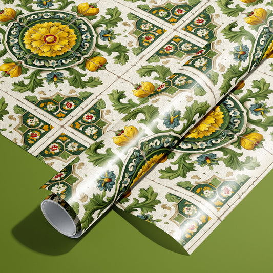 A roll of Golden Girasole wrapping paper resting on a full sheet, with Italian majolica sunflower medallions and green acanthus scrolls on an olive green background.
