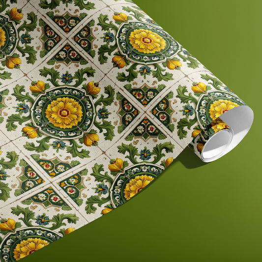 A partially unfurled roll of Golden Girasole wrapping paper showcasing baroque tile motifs with yellow sunflower rosettes and leafy scrollwork on an olive green surface.