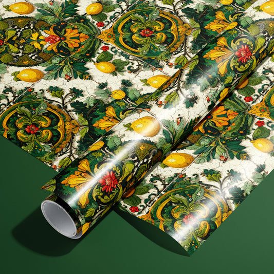 A roll of Amalfi Acanthus wrapping paper resting on a full sheet, featuring baroque acanthus scrolls, lemons, and floral medallions on a deep green background.