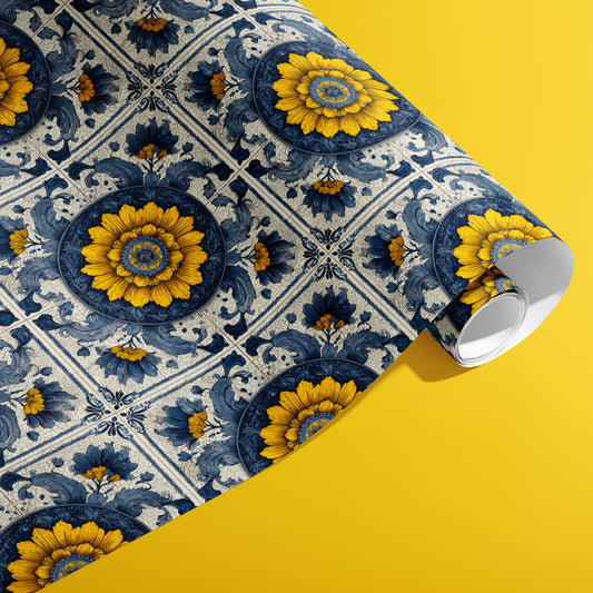A partially unfurled roll of Lapis Florale wrapping paper featuring ornate blue tile motifs with golden floral medallions against a vivid yellow surface.