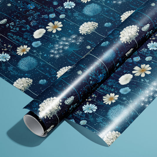 A roll on an unrolled sheet of Midnight Garden wrapping paper with nocturnal florals, butterflies, and starry speckles on deep navy, set on a teal background.