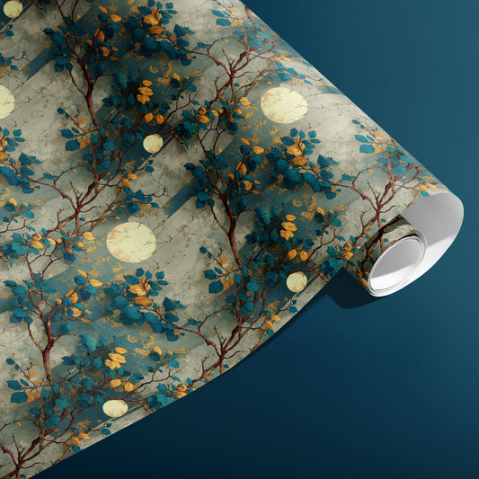 A partially unfurled roll of Verdigris Trellis gift wrap reveals branch-and-leaf motifs with pale moon discs on a distressed verdigris pattern, styled on a deep teal background.