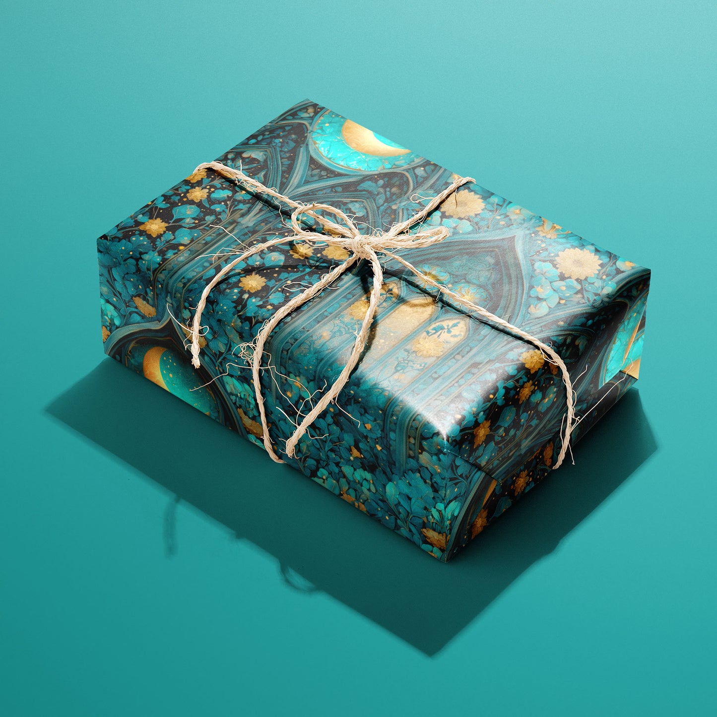 A single gift wrapped in Wisteria Cathedral paper, tied with natural twine, displays gothic arches, crescent moons, and teal-and-gold florals against a teal background.
