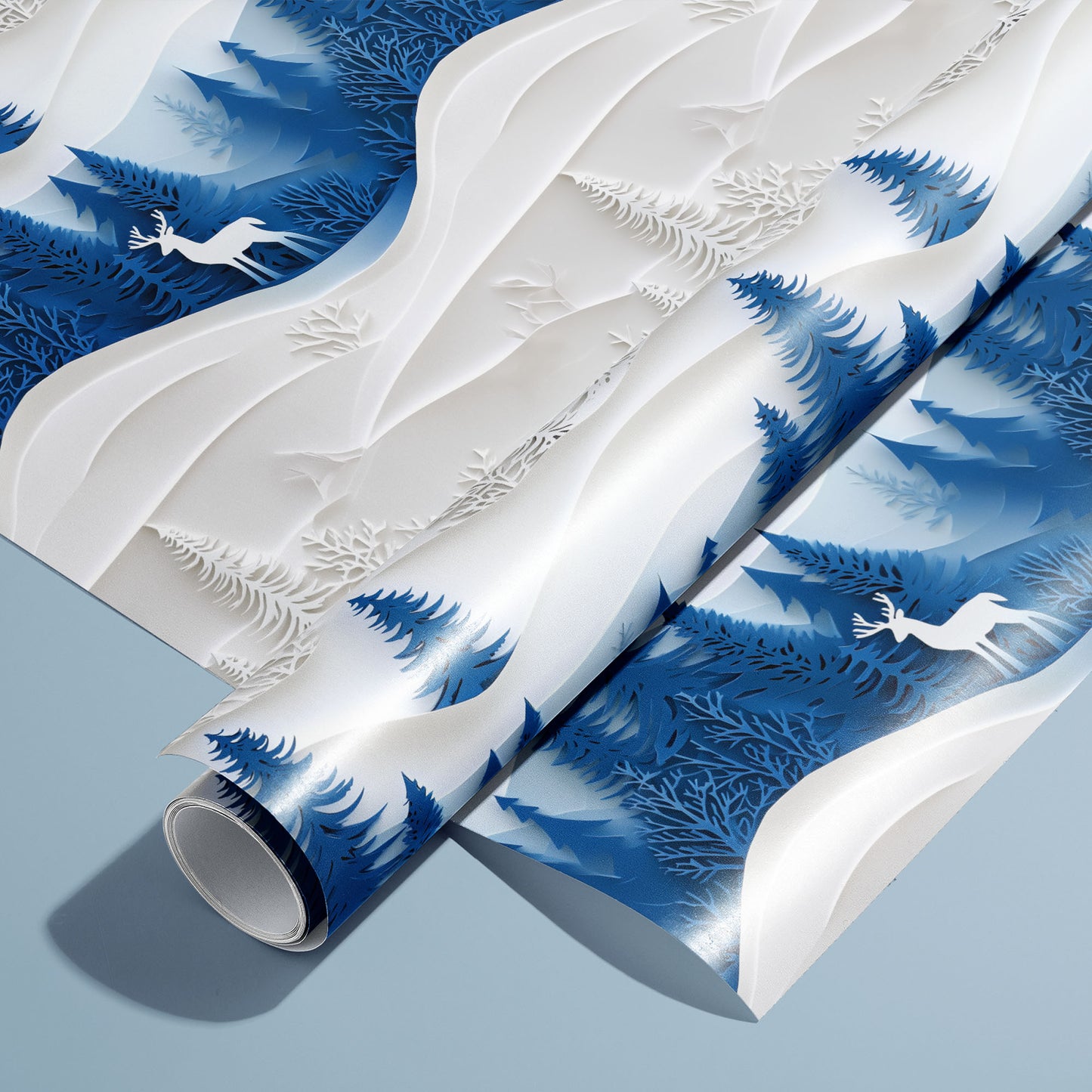 A roll of Alpine Serenity wrapping paper on an unrolled sheet, featuring snowy mountain peaks, fir trees, and twinkling stars on deep blue, set on a cool slate-blue surface.