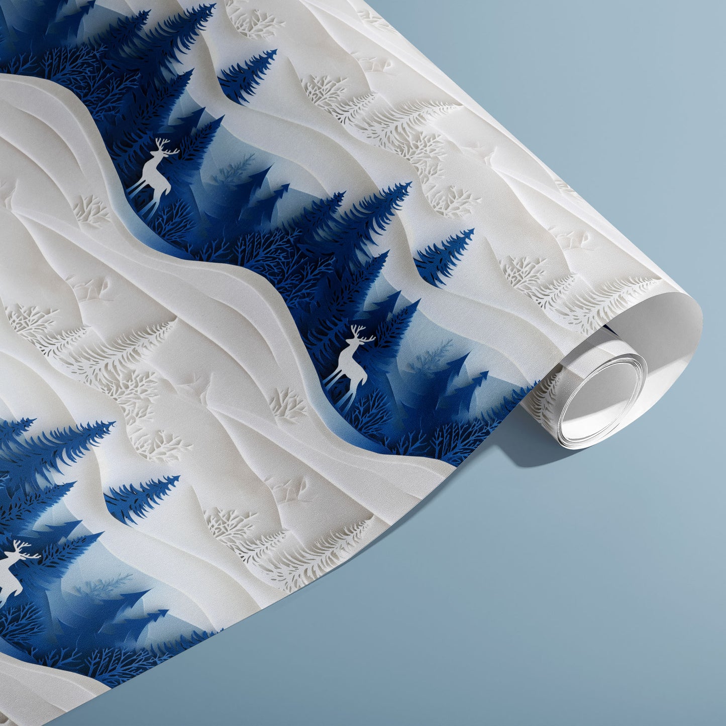 A partially unfurled roll of Alpine Serenity wrapping paper showing serene alpine peaks and evergreen silhouettes on a deep blue ground, on a cool slate-blue surface.