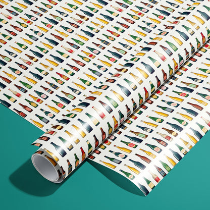 A roll of Artistic Ales rests on an unrolled sheet, featuring painterly beer bottles and foaming pints with hops and barley motifs, styled on a teal surface.