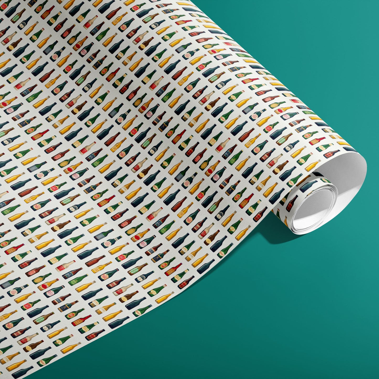 A partially unfurled roll of Artistic Ales gift wrap shows illustrated pint glasses, bottles, hops, and barley in a lively, painterly style against a teal background.