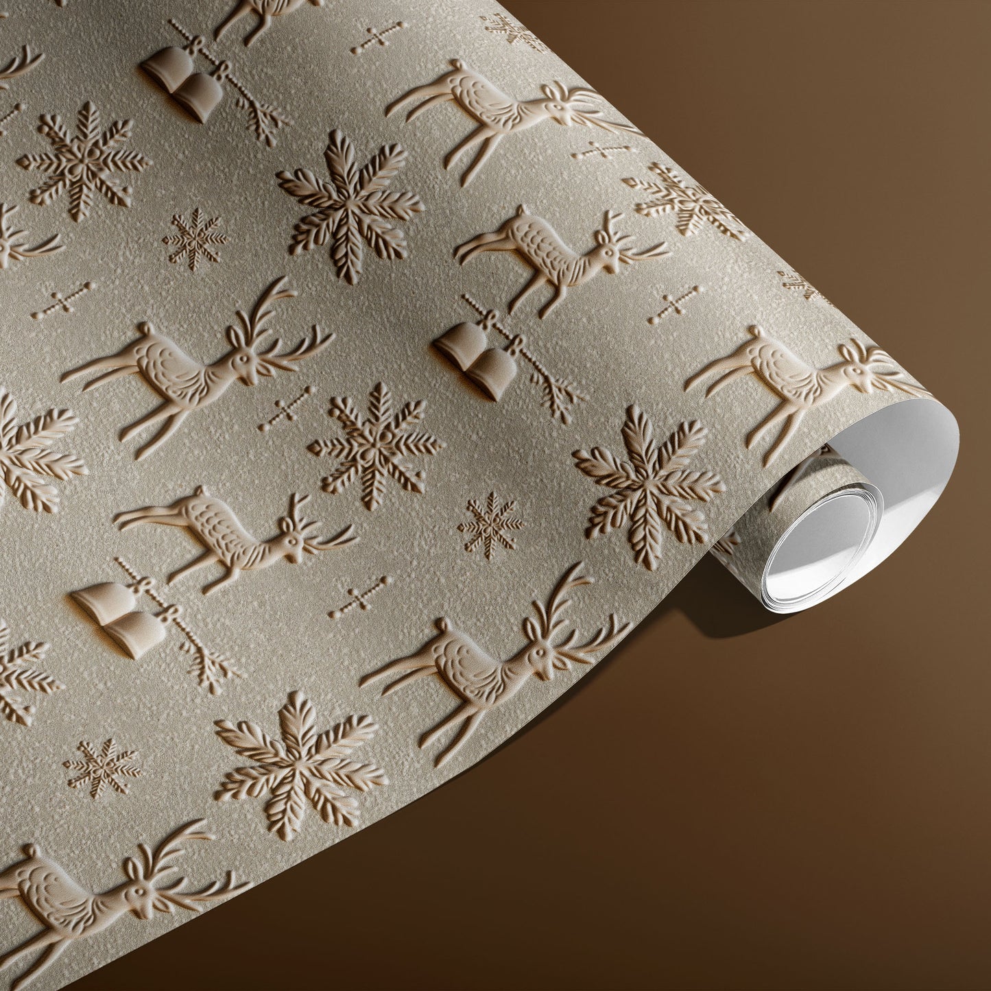 A partially unfurled roll of Winter Impressions with its white underside visible beside a spool of natural twine, featuring embossed-look reindeer and snowflakes on a pale stone ground over a warm brown surface.