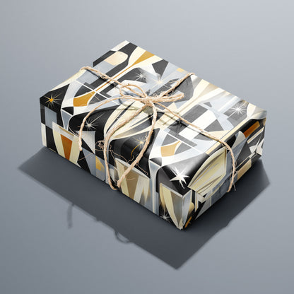 A single gift wrapped in Toast to Elegance and tied with natural twine, displaying champagne flutes, bubbles, and starbursts in soft gold on black, set on a silver-grey surface.